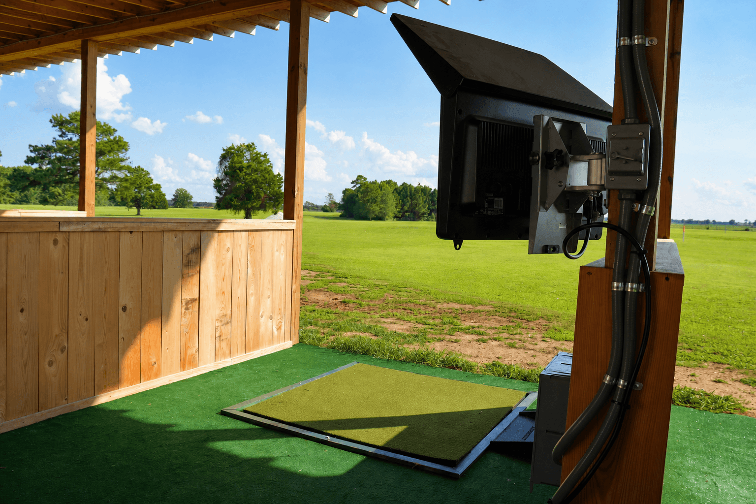 Toptracer equipment and hitting mat detail in an empty bay