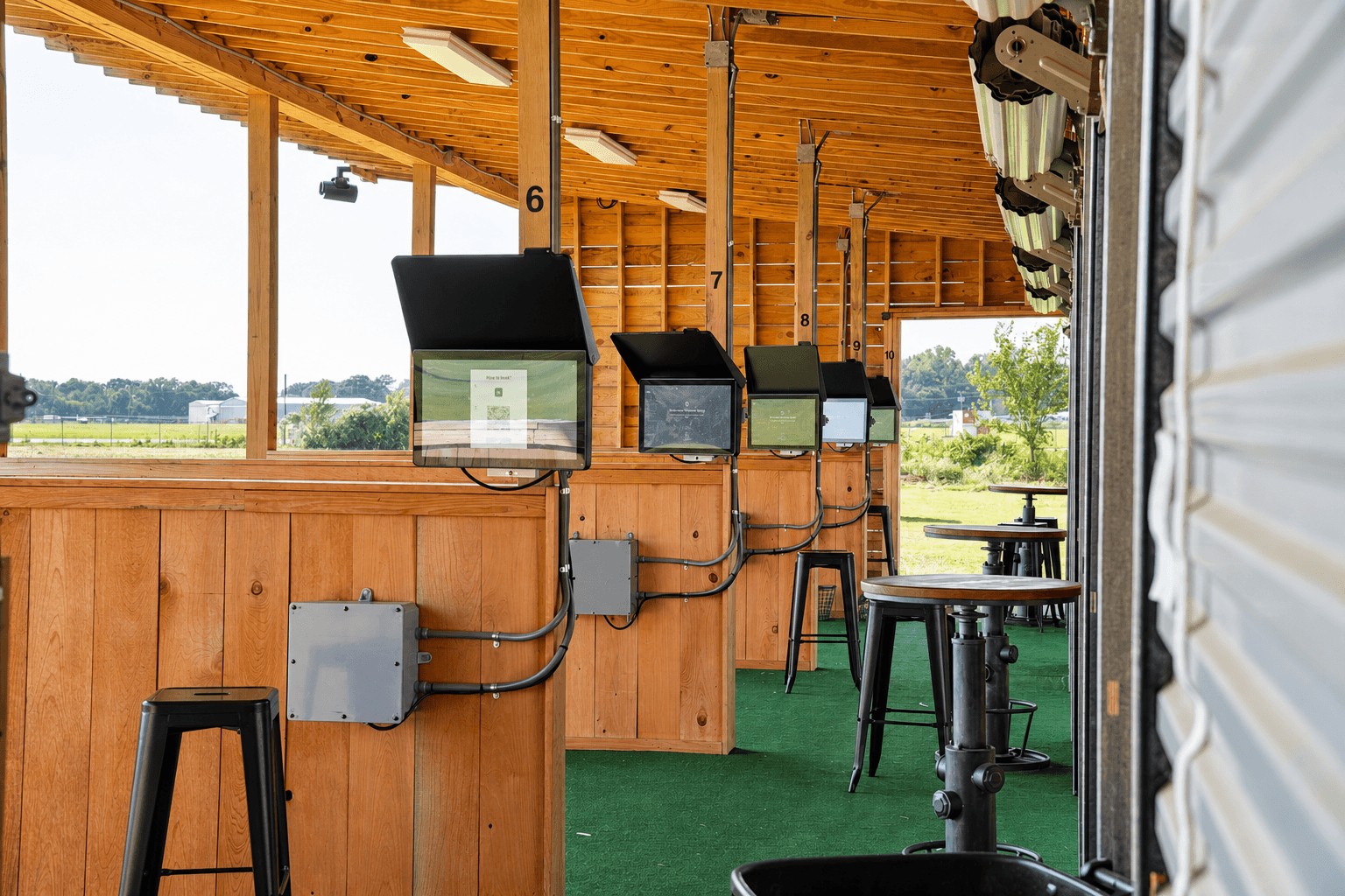 Inside The Hangar — all Toptracer bay screens active at High Pointe Golf