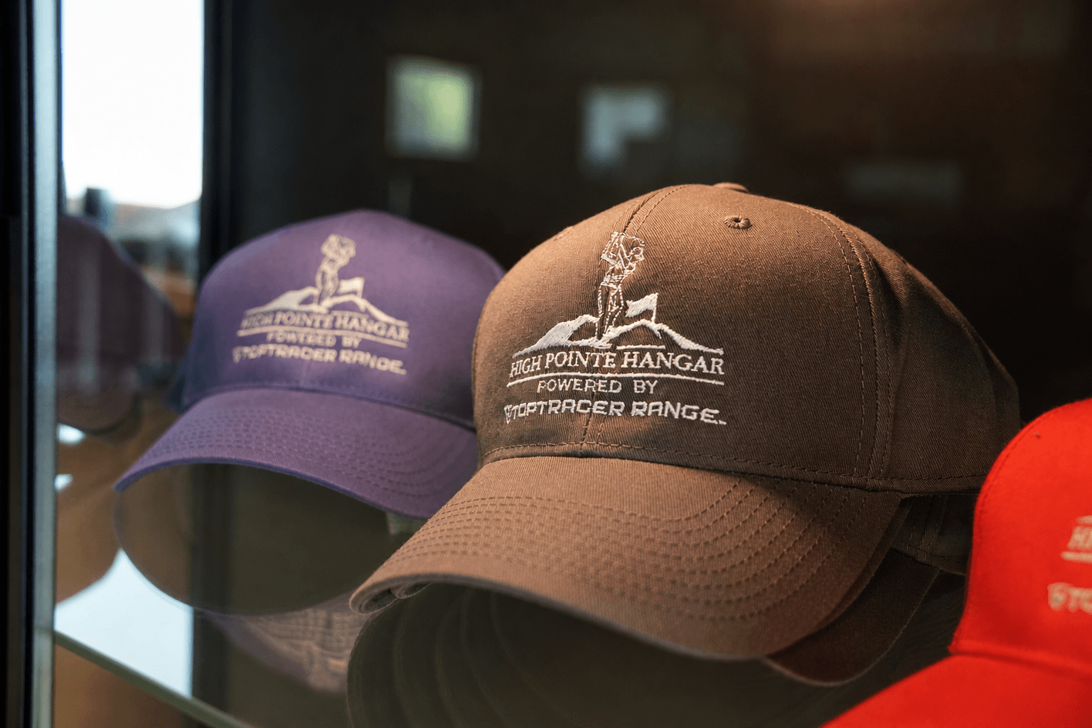 High Pointe Hangar branded hats on display — merchandise at The Hangar